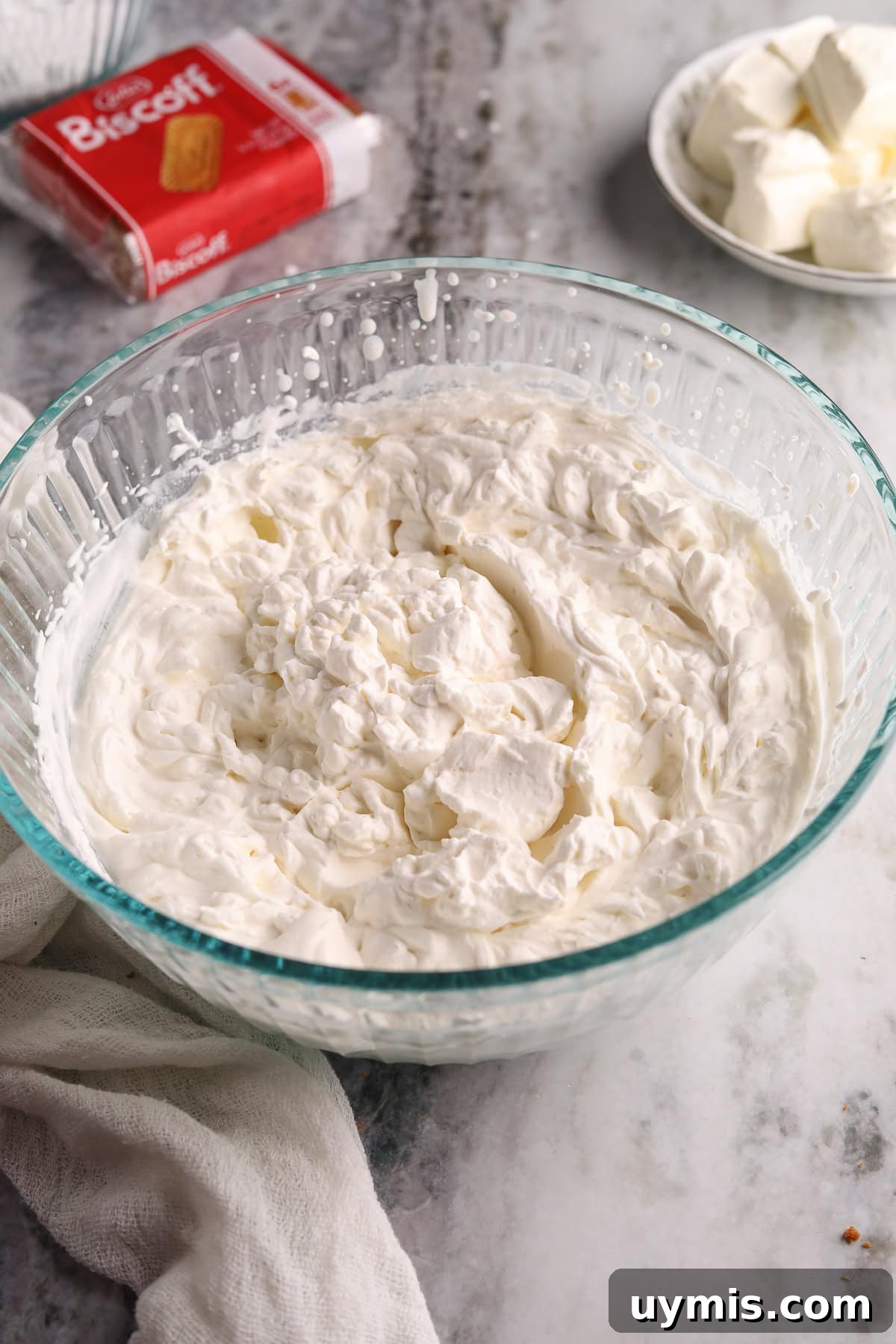 Creamy No-Bake Cookie Butter Pie Recipe 5 Whipped cream for cookie butter pie in a clear glass bowl.