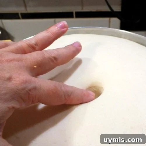 Pushing a finger in bread dough to check if it's risen.