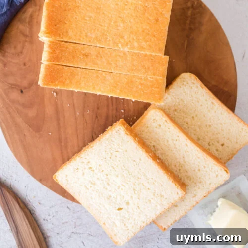 Overhead view of slices of pullman loaf bread on a cutting board.