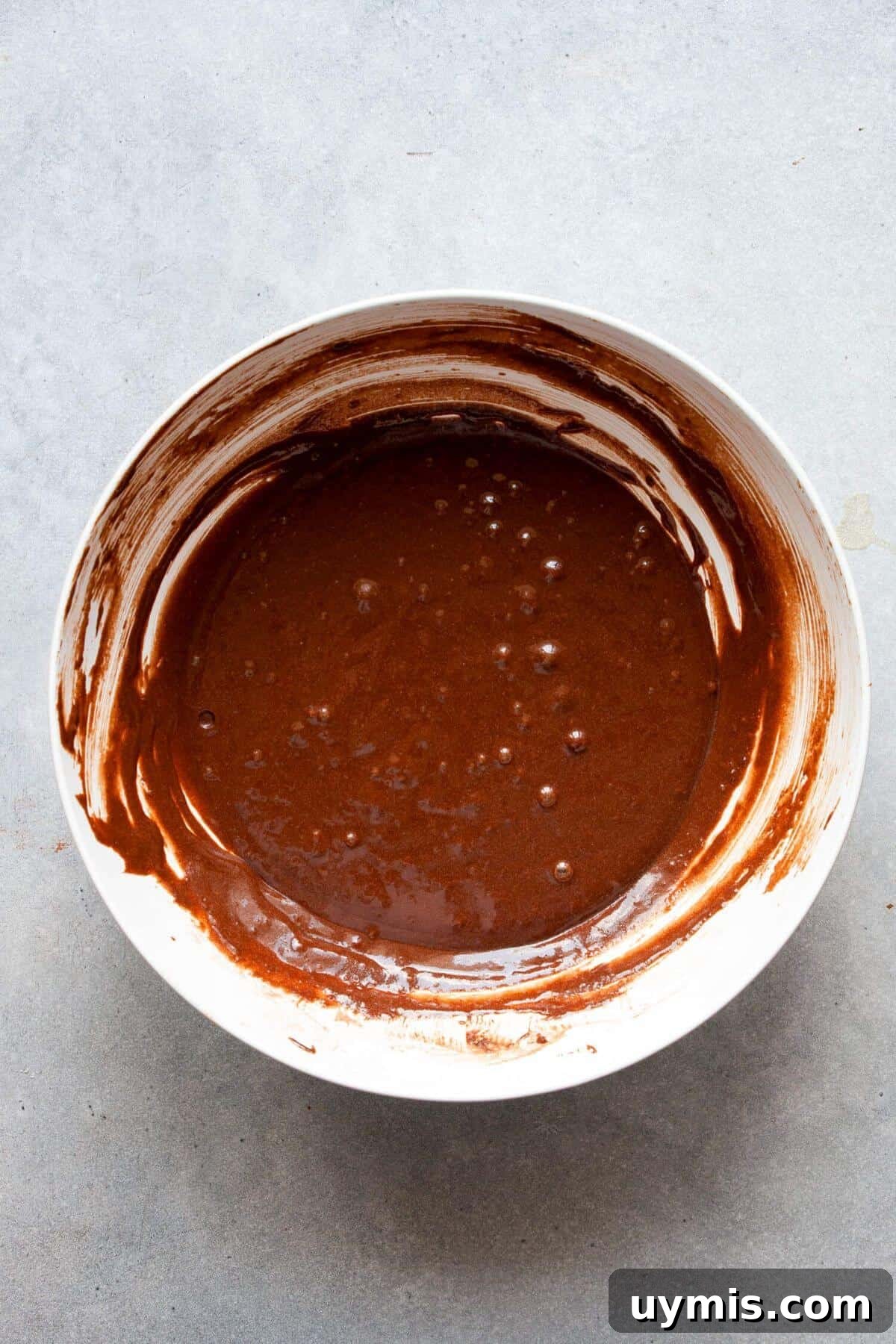 Fudgy Gluten Free Chocolate Cupcakes Recipe 5 Smooth chocolate cupcake batter made with gluten-free flour and cocoa powder in a bowl.
