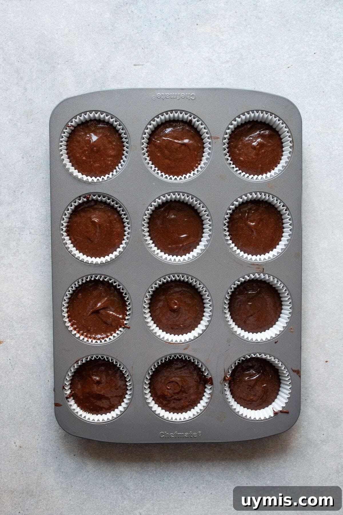 Fudgy Gluten Free Chocolate Cupcakes Recipe 6 Gluten-free chocolate cupcake batter divided into paper-lined cupcake tin.