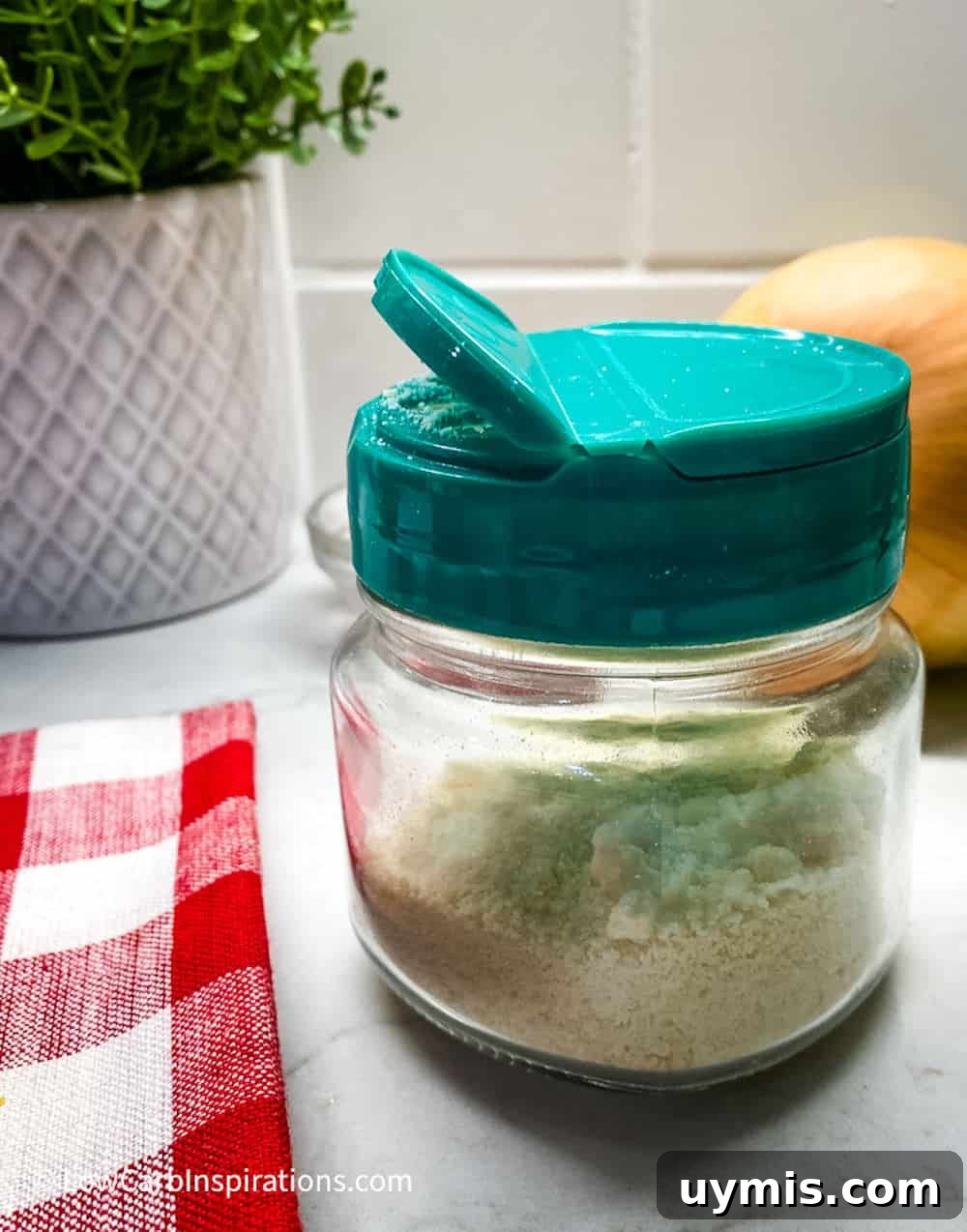 2 Ingredient Keto Pasta Recipe for Low Carb Noodles 11 Small mason jar with a green shaker lid and the jar is filled with parmesan cheese