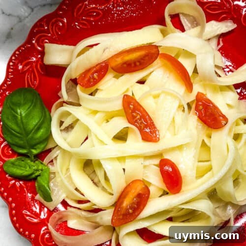 Buttered pasta noodles with cherry tomatoes and basil