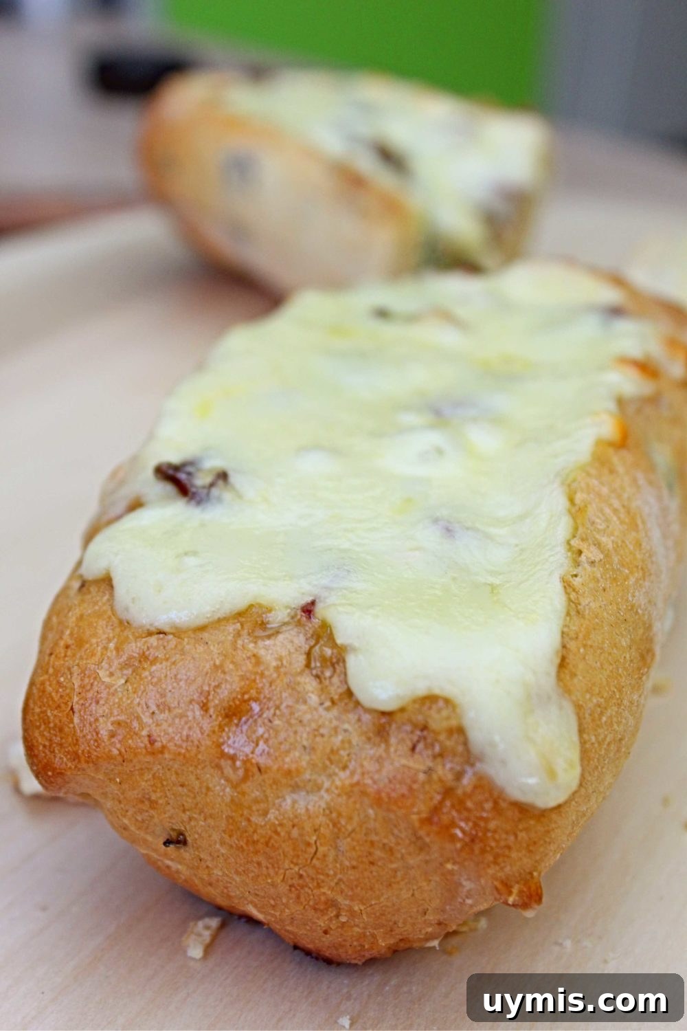 Oven-Baked Egg Boats: Savory Breakfast Omelette Recipe 2 Egg boat for breakfast with baked omelette with ham, cheese, mushrooms and scallion, on a cutting board