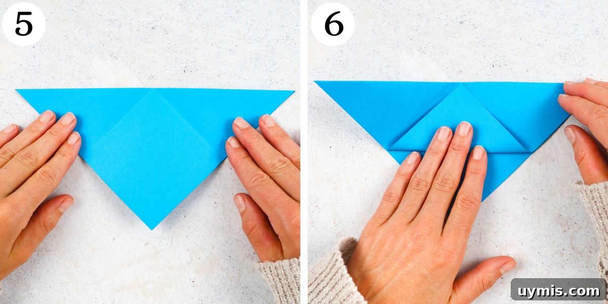 How to Make an Origami Corner Bookmark 6 fold top flap of the triangle point upward so that it meets the top edge.