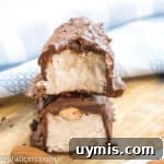 Up close picture of almond joy fat bombs cut in half showing the almond and filling