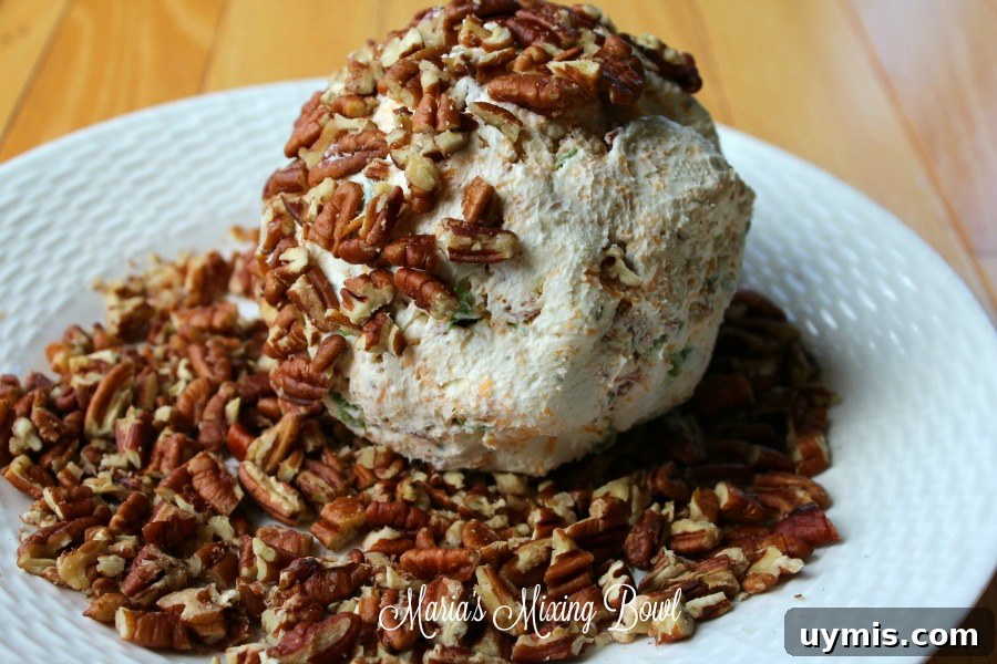 Cheddar Bacon Ranch Cheese Ball Recipe 9 Rolling cheese ball in pecans