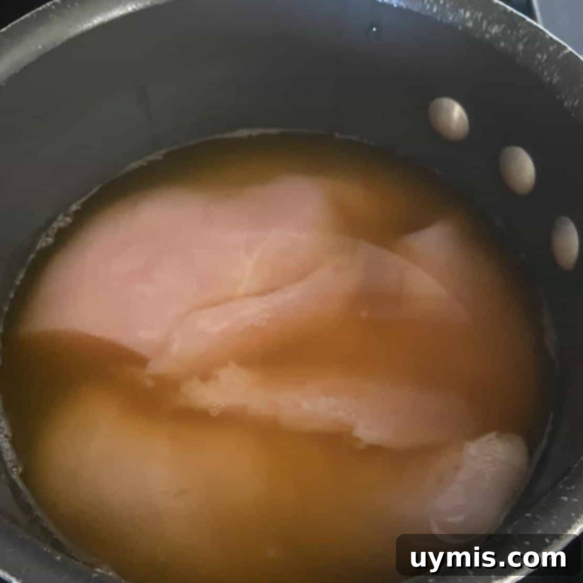 Raw Chicken breast in pot.