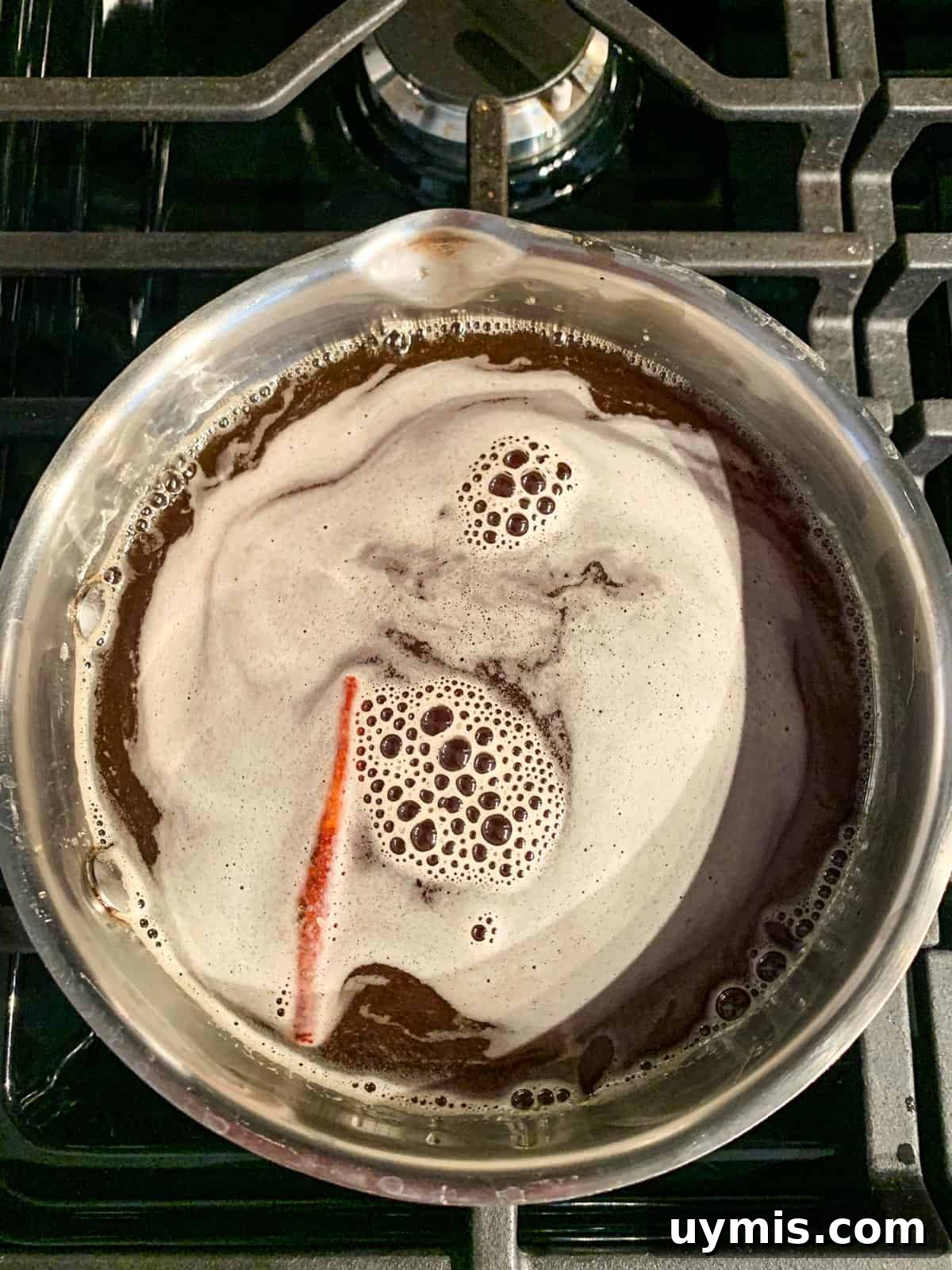 Apple brown sugar syrup simmering in a pot.