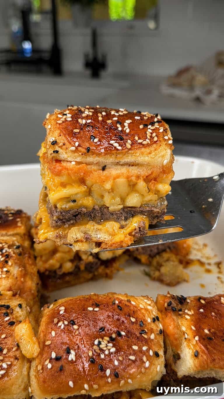 Why I Switched to Caraway Cookware: One-Pan Dinner for Two 8 A spatula lifts a square sandwich from a baking dish, showing layers of ground beef and macaroni with cheese.