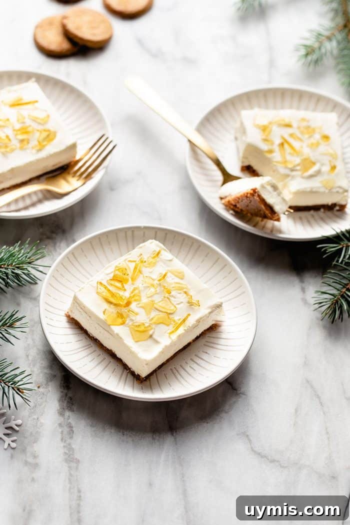 Three white plates each with a slice of no-bake cheesecake bar with sugar topping