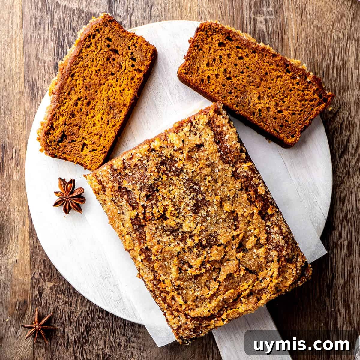 Moist Pumpkin Bread Recipe with Warm Spices 5 Healthy Pumpkin Bread on a cutting board with 2 slices cut out of it