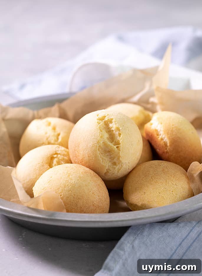 A round metal tin with 8 rolls of pan de bono