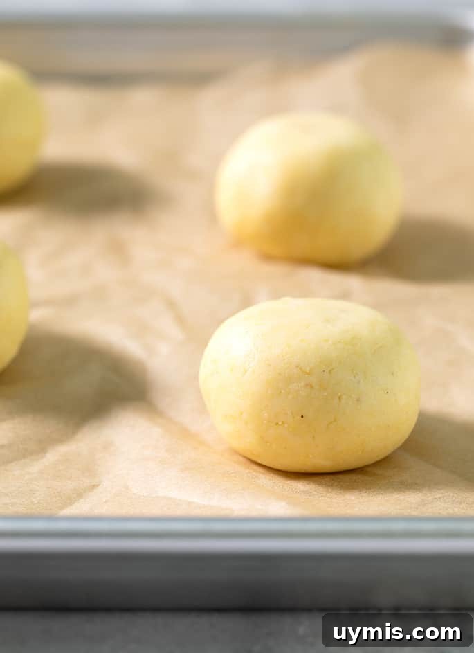 Raw balls of pan de bono on a tray