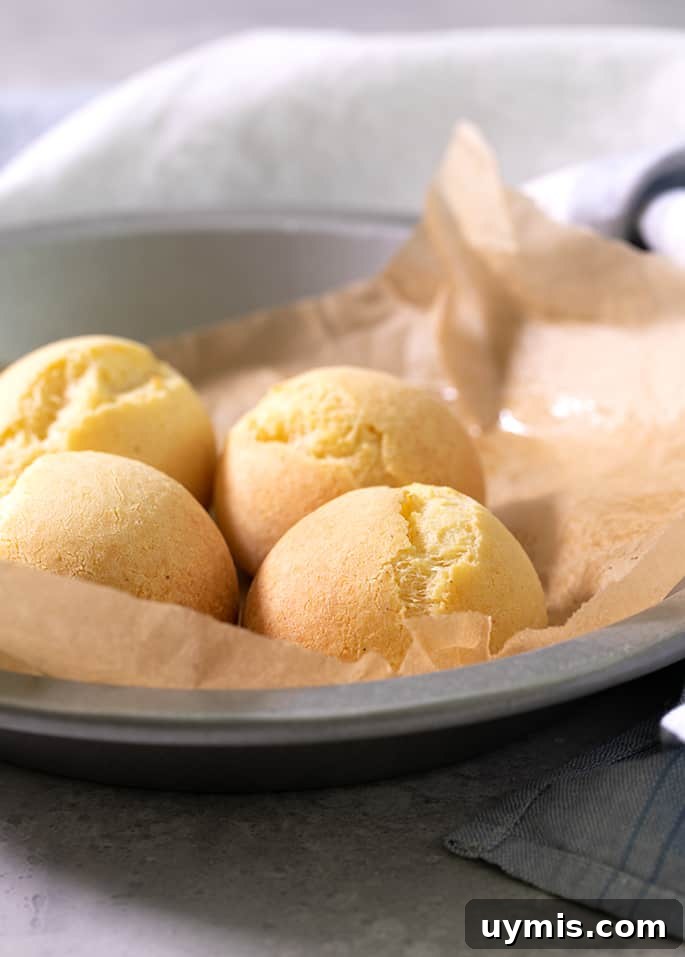 A round tin with brown paper and 4 pan de bono rolls