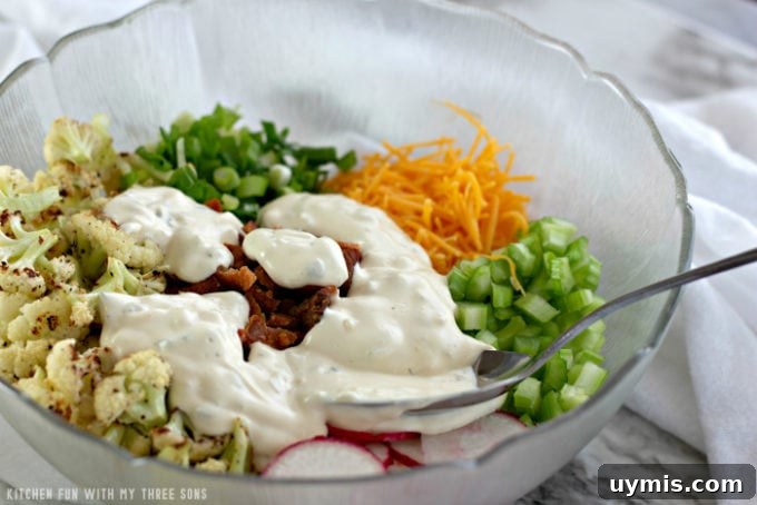 Tossing together a cauliflower salad in a clear bowl