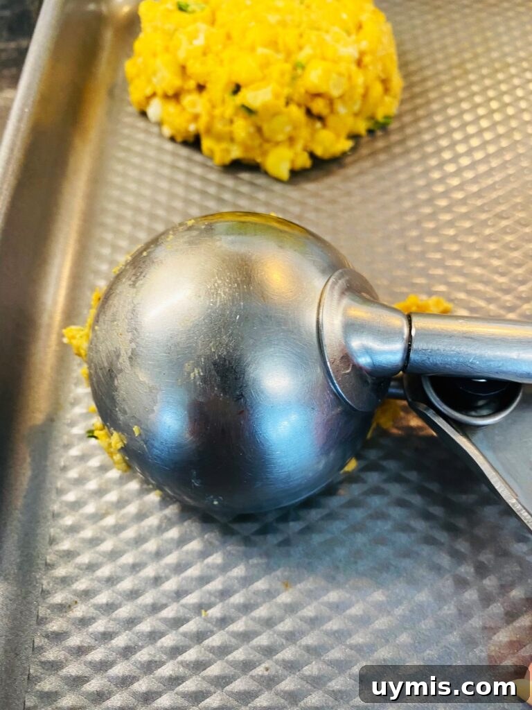 Blackstone Street Corn Fritters Recipe 6 scooping the fritters with an ice cream scooper