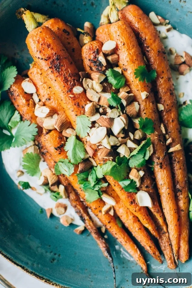 Black Pepper Roasted Carrots with Cilantro Yogurt and Almonds 2 Black pepper roasted carrots with savory cilantro yogurt and roasted almonds are easy, flavorful, and finished with a bright cilantro yogurt sauce and crunchy toasted almonds.