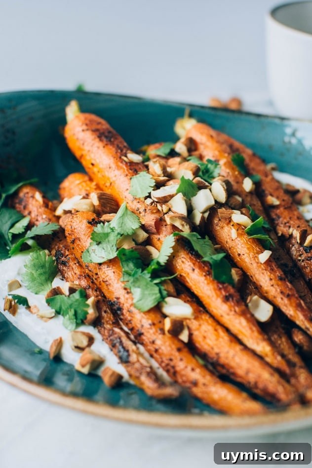 Black Pepper Roasted Carrots with Cilantro Yogurt and Almonds 3 Roasted carrots seasoned with black pepper and smoked paprika served with cilantro yogurt and toasted almonds.