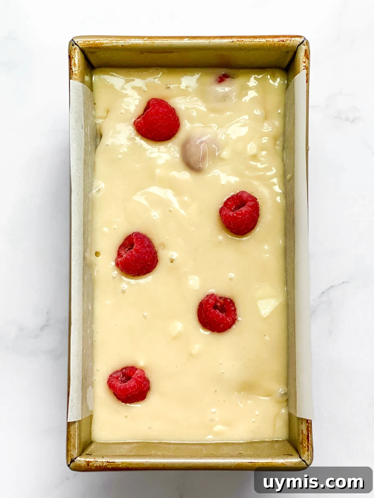 White Chocolate Raspberry Loaf Cake 11 loaf cake in pan before baking.