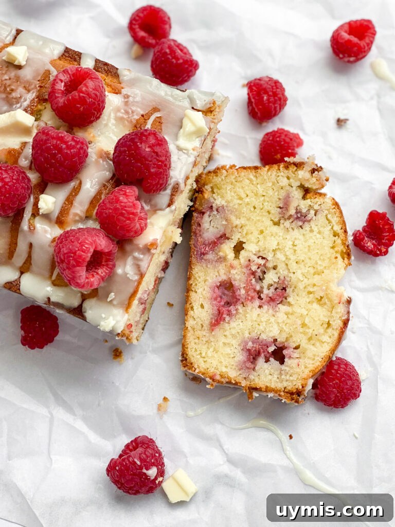 White Chocolate Raspberry Loaf Cake 16 aerial view of raspberry white chocolate loaf cake with a slice cut.