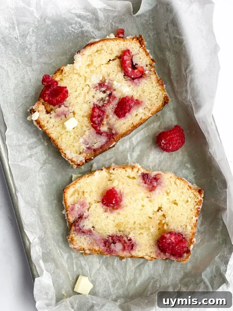 White Chocolate Raspberry Loaf Cake 4 2 slices of raspberry white chocolate loaf cake laying side by side.