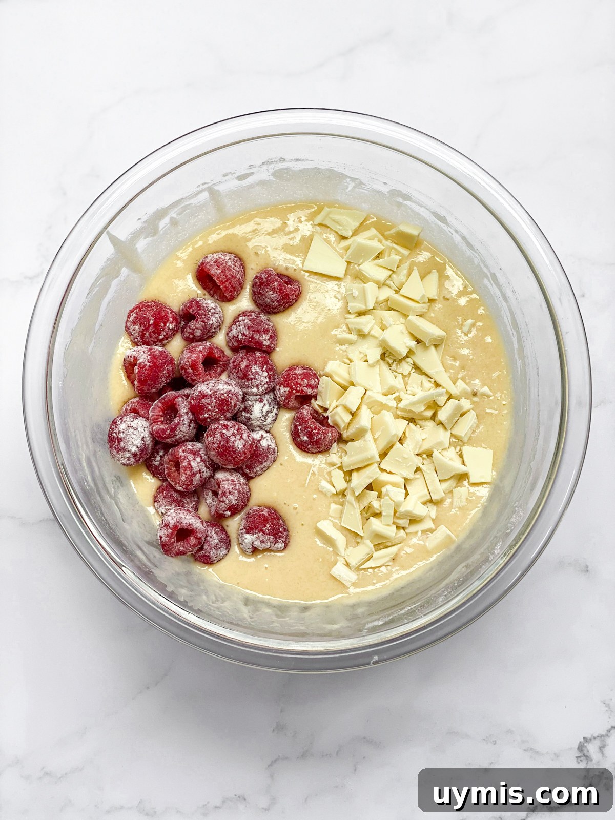 White Chocolate Raspberry Loaf Cake 9 adding white chocolate and raspberries to batter.