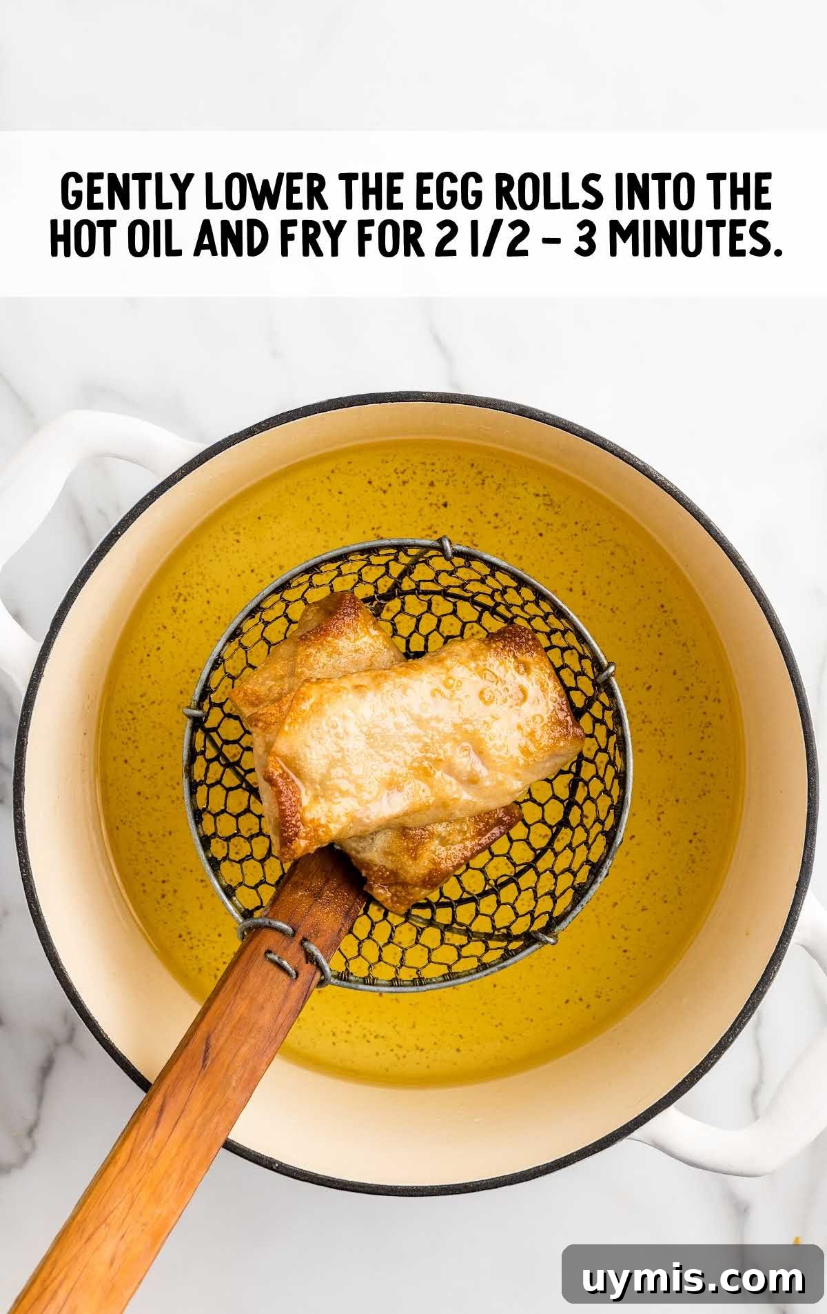 egg rolls cooked in a pot of hot oil
