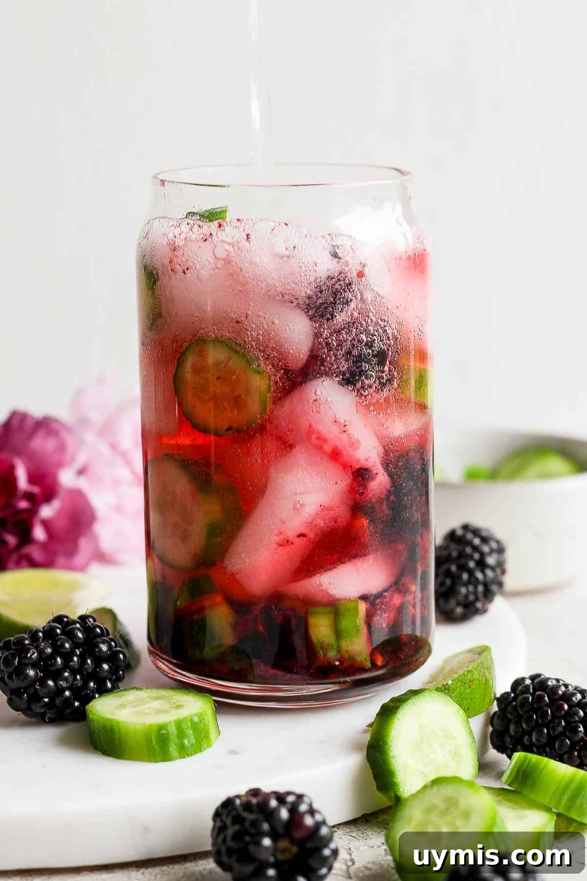 Ice, lime juice, gin, and a splash of tonic water added to the glass.
