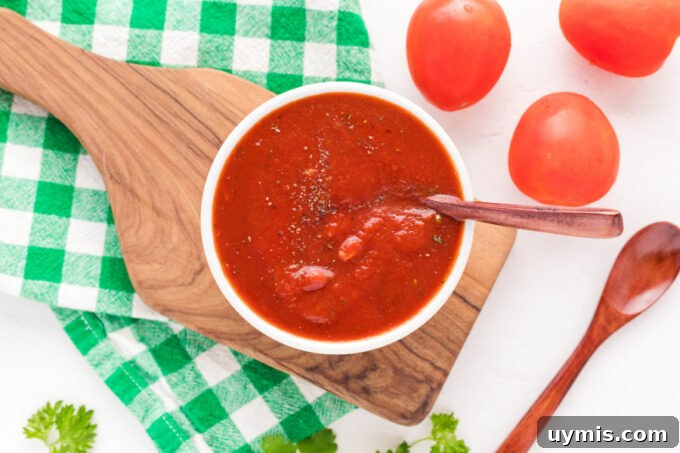 Homemade Pizza Sauce Recipe Without Tomato Paste 7 Bowl of pizza sauce on a cutting board.