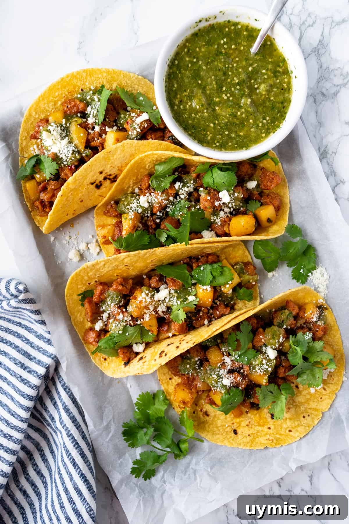 Chorizo Tacos with Salsa Verde Recipe 2 Chorizo Tacos with Salsa Verde on a baking sheet.
