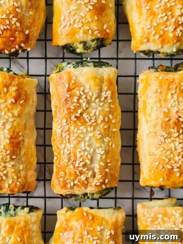Golden spinach and ricotta rolls on a cooling rack
