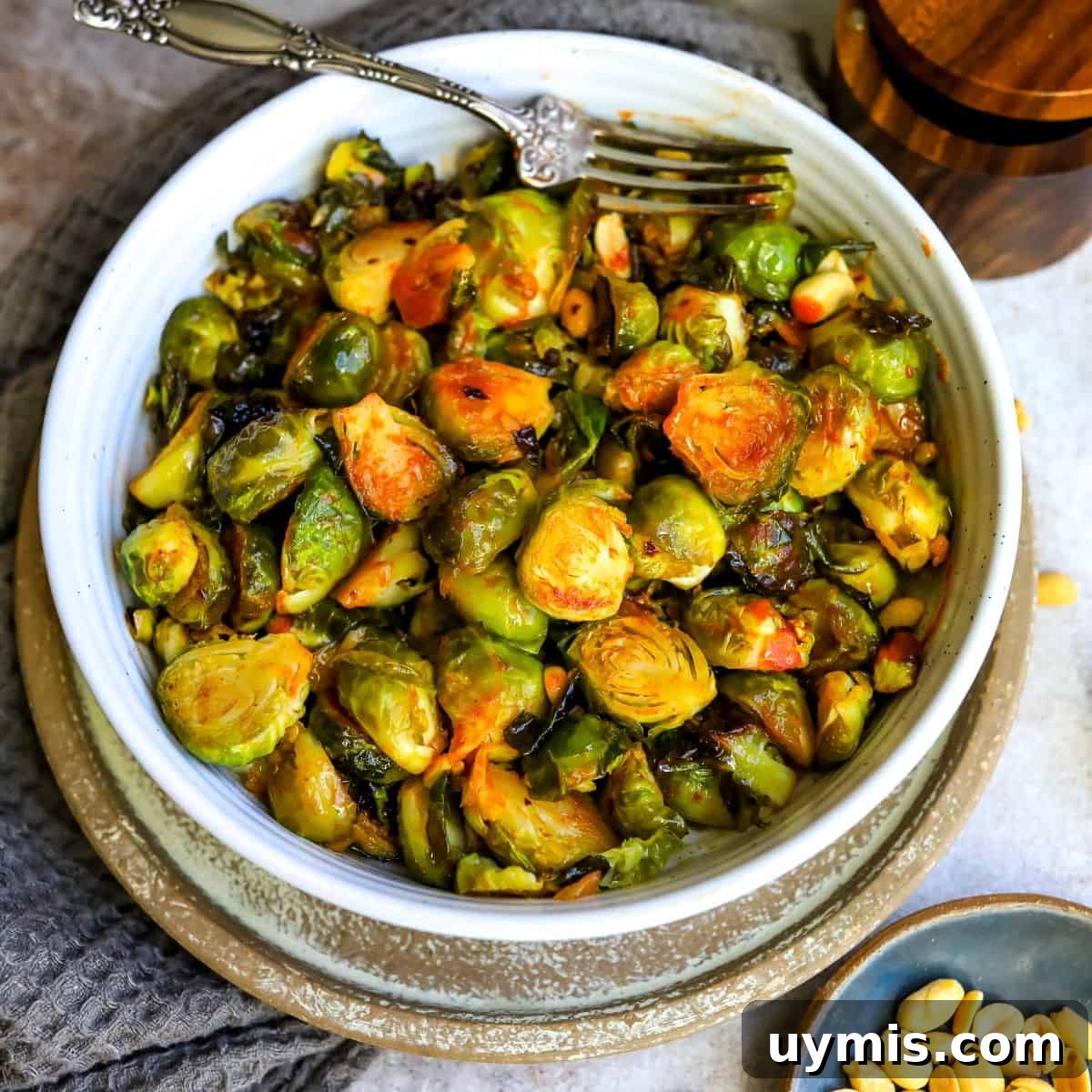 Crispy Honey Sriracha Brussels Sprouts 7 Honey Sriracha Brussels sprouts served in a white bowl.