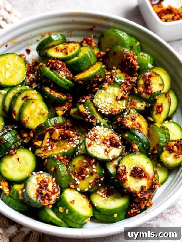 Crispy Honey Sriracha Brussels Sprouts 10 Spicy cucumber salad in a white ceramic bowl with spicy crunch.