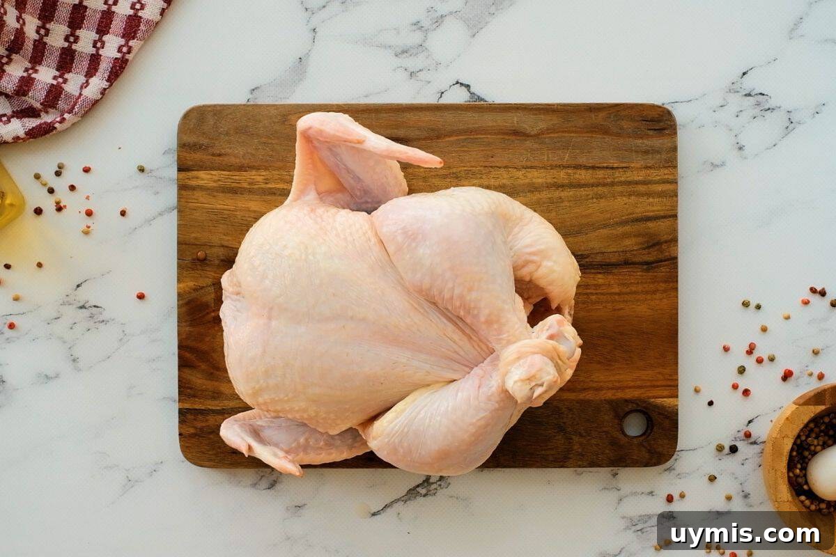 Whole chicken on a cutting board.