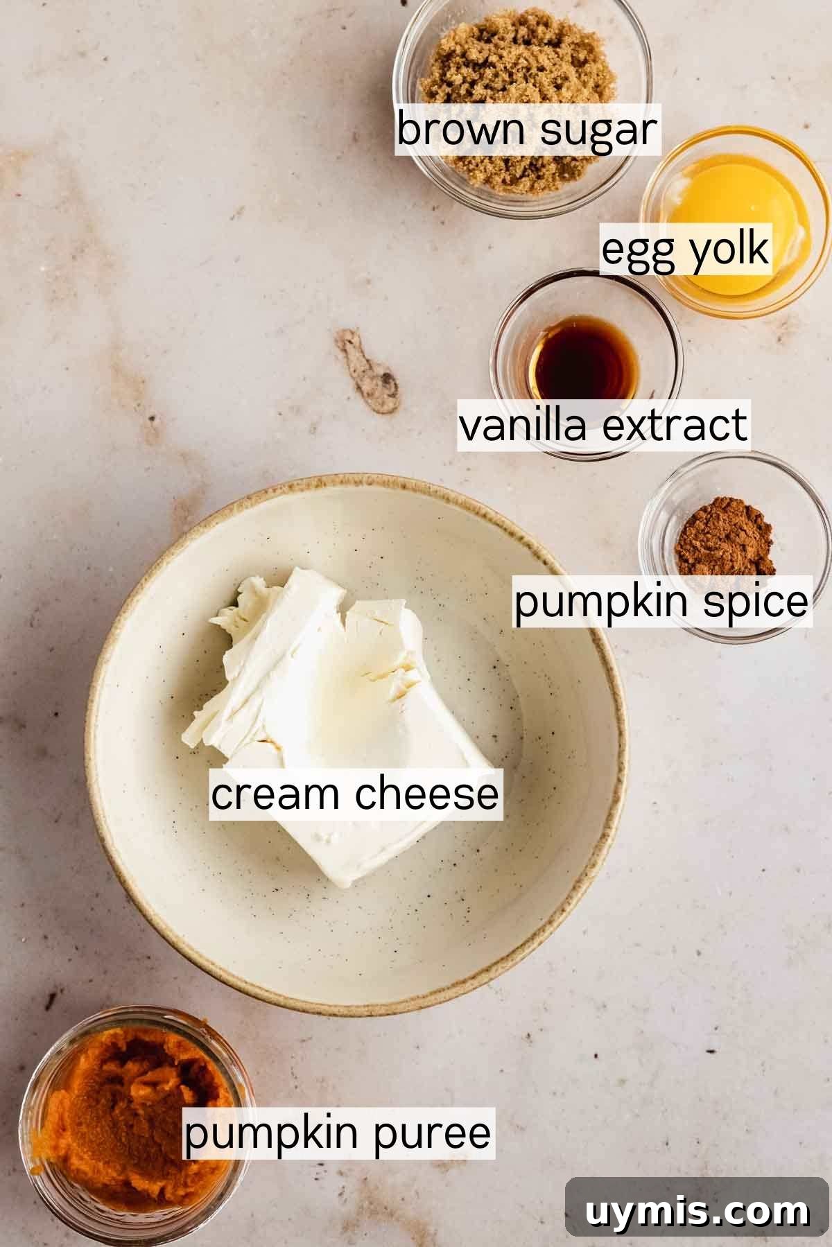 Soft Pumpkin Cheesecake Cookies with Cream Cheese Swirl 4 brown sugar, egg yolk, vanilla extract, pumpkin spice, cream cheese, and pumpkin puree in little bowls