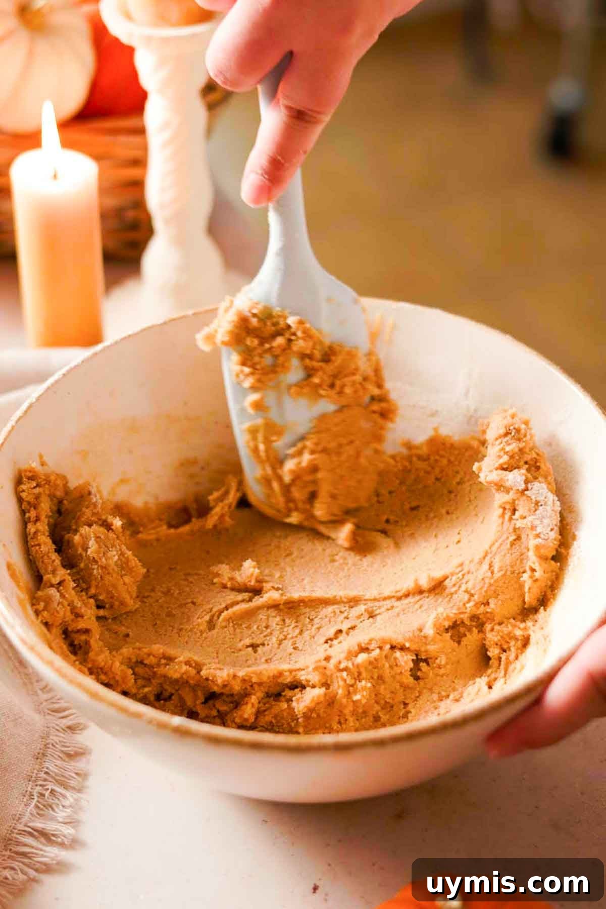 Soft Pumpkin Cheesecake Cookies with Cream Cheese Swirl 6 smoothing down the cookie dough in a large bowl with a rubber spatula