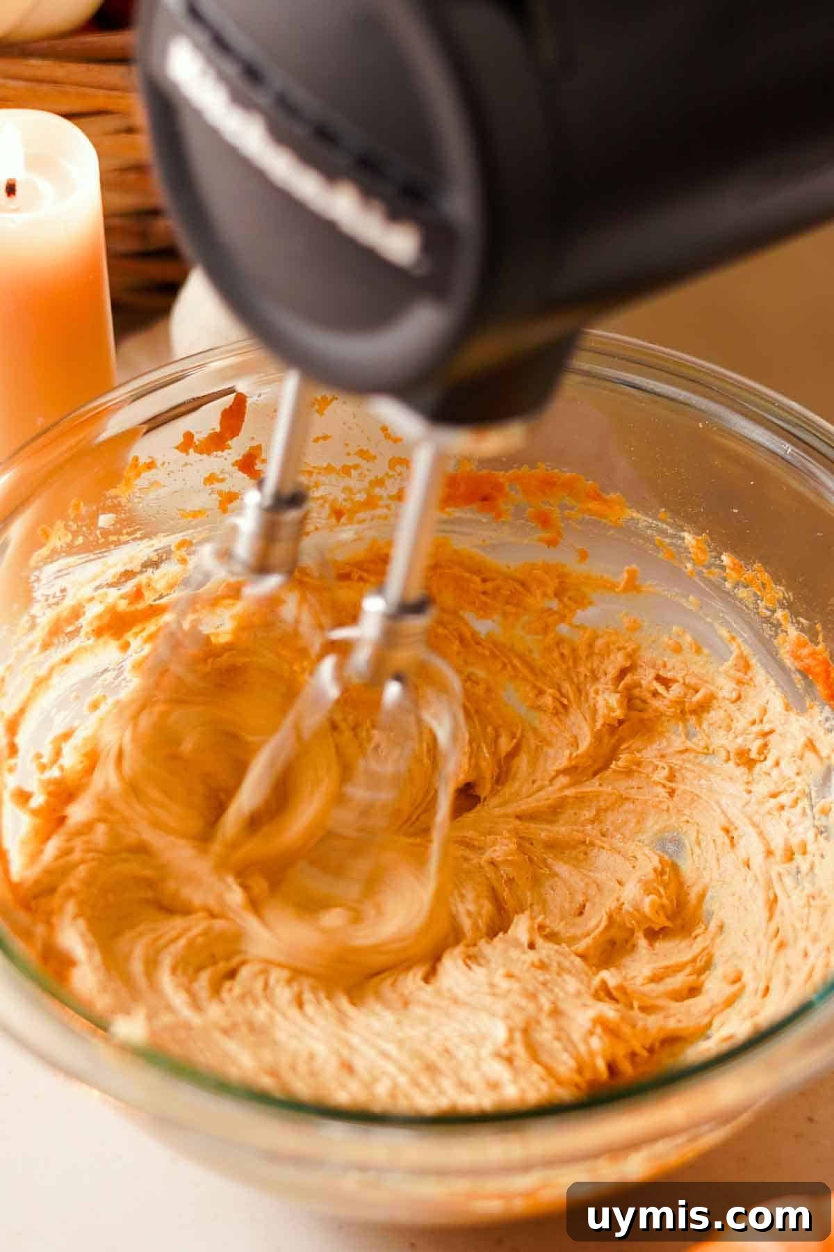 Soft Pumpkin Cheesecake Cookies with Cream Cheese Swirl 9 beating the cream cheese cookie filling in a glass bowl with a black electric mixer