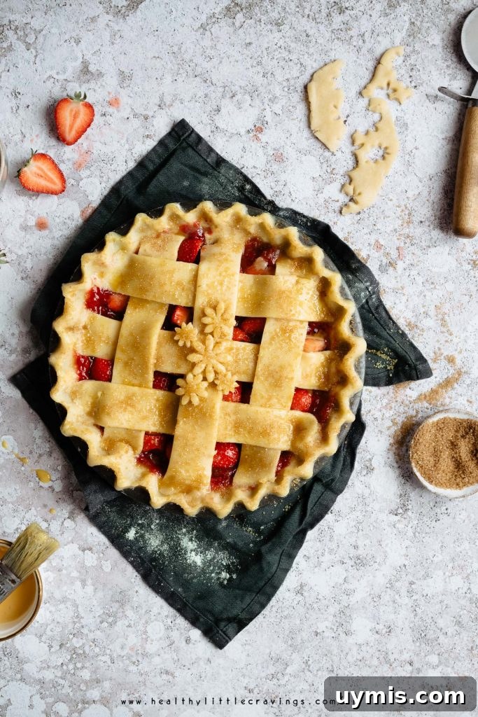 A raw strawberry pie with cinnamon sugar sprinkled on top, onto a green napkin 