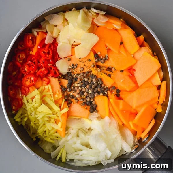 Spicy Refrigerator Pumpkin Pickles Recipe 5 Saucepan with sliced pumpkin, onions, ginger, red chili peppers, garlic and black peppercorns