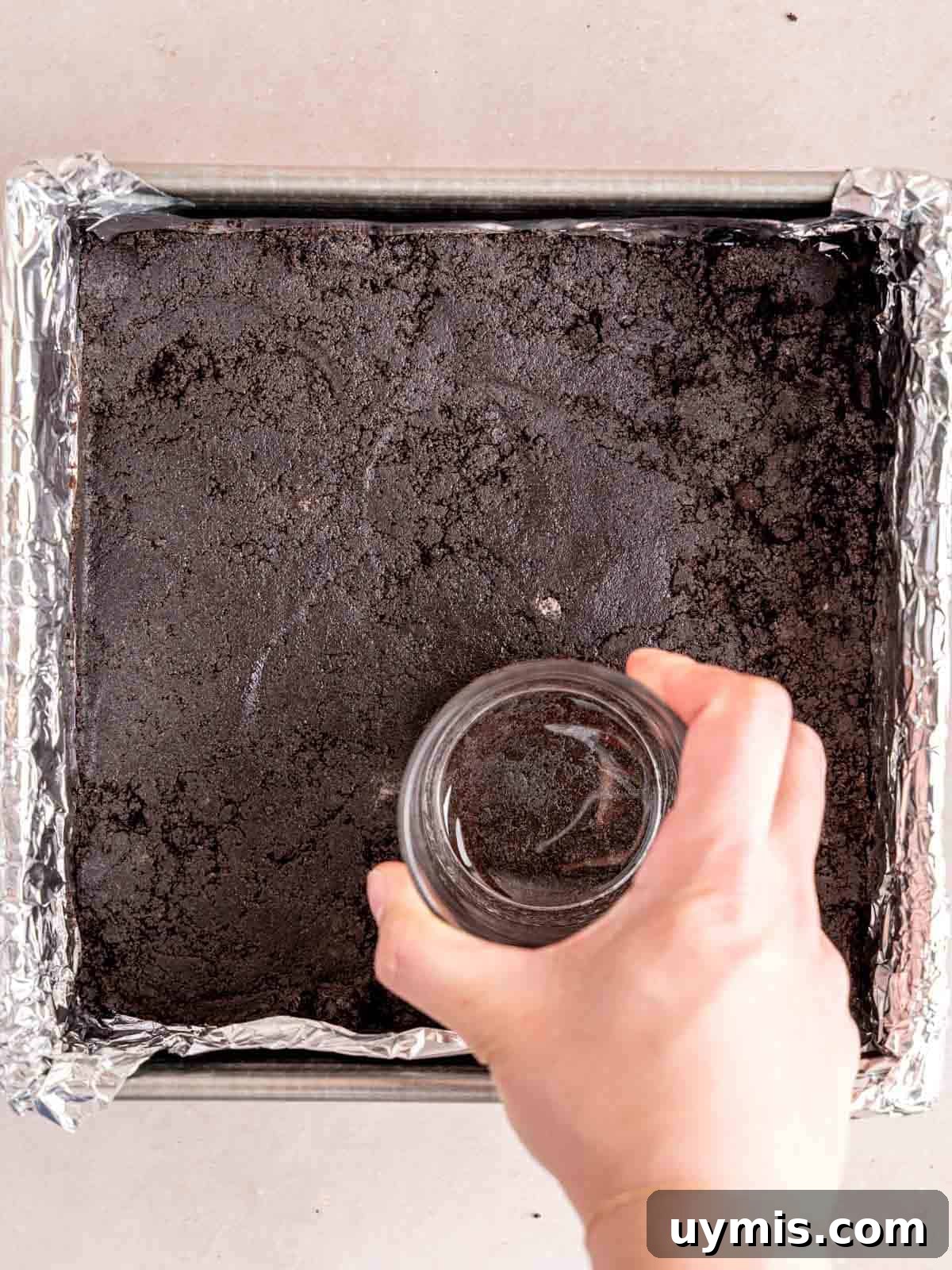 Creamy No-Bake Chocolate Cherry Cheesecake Recipe 5 Pressing Oreo crumbs into the bottom of an 8x8 inch pan.