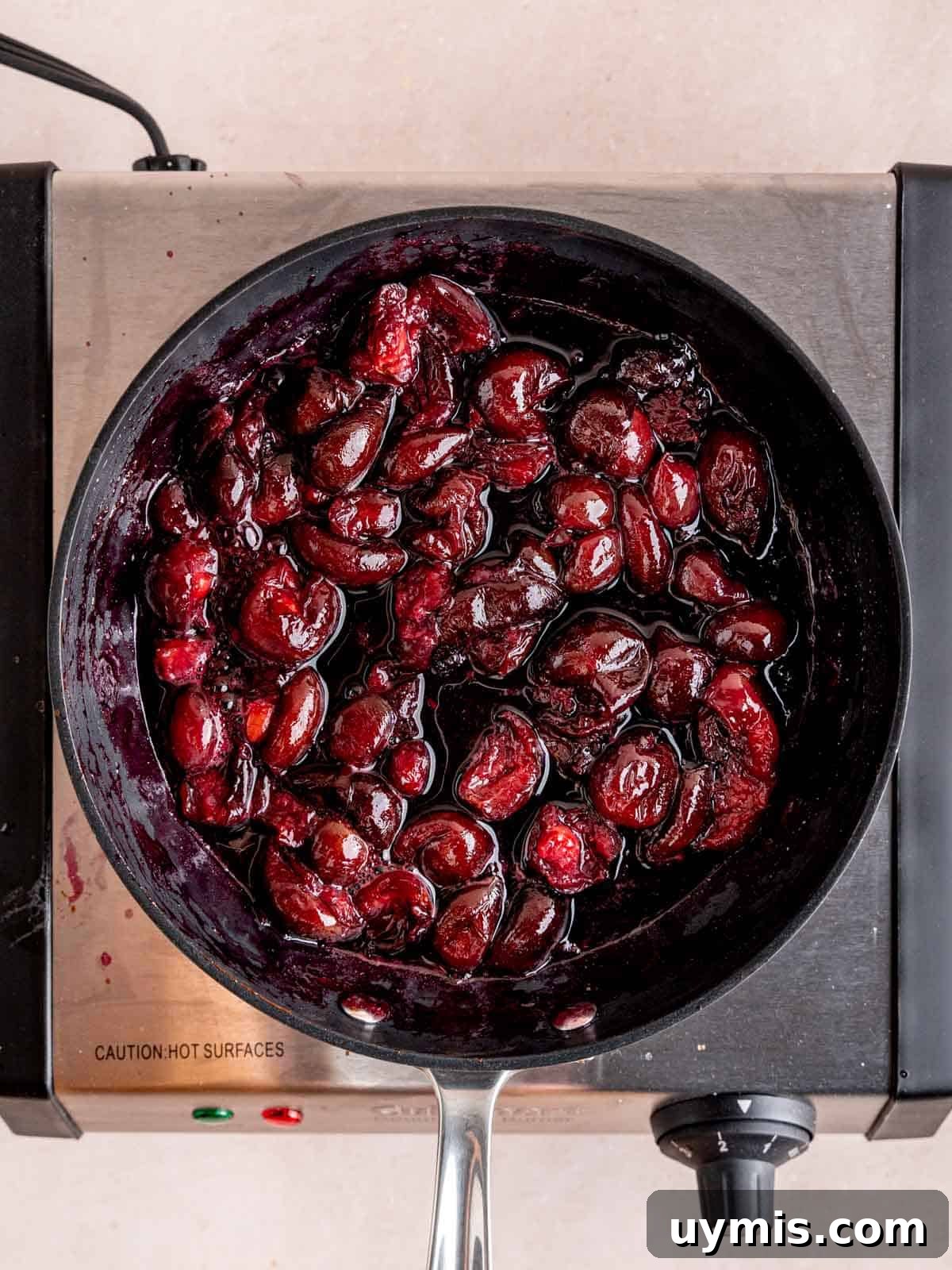 Creamy No-Bake Chocolate Cherry Cheesecake Recipe 6 Cooking cherries with sugar in a nonstick skillet.