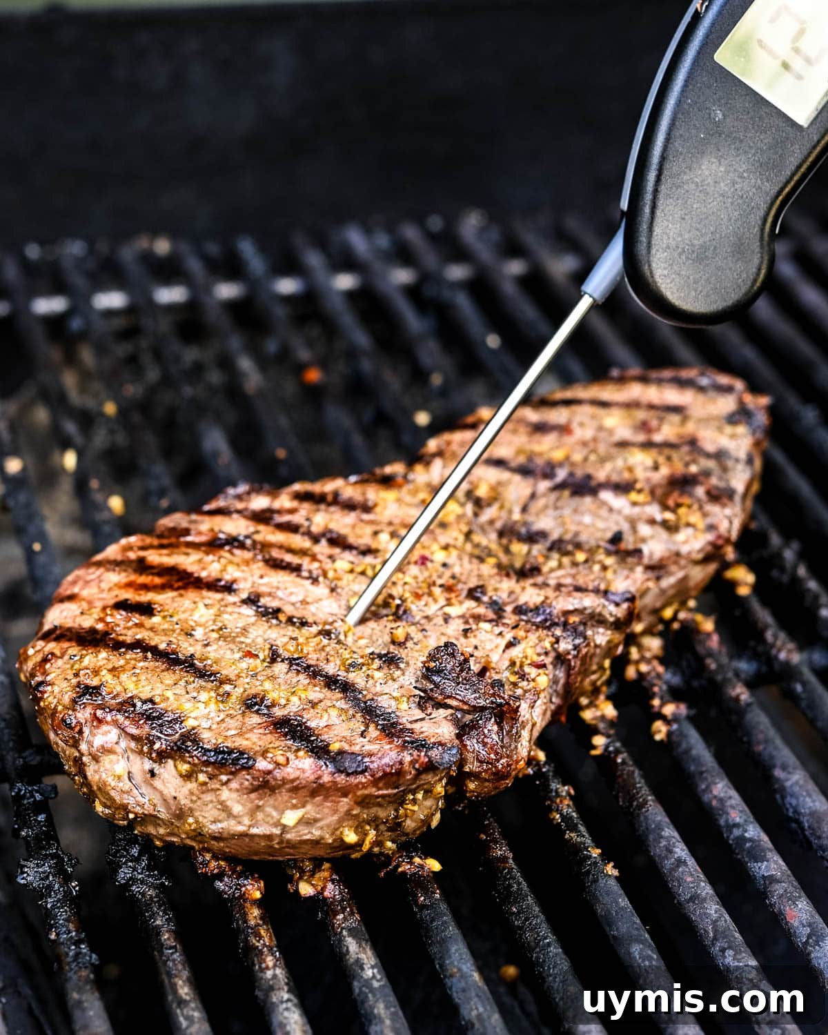 Carne Asada Tacos with Juicy Grilled Steak 6 Grilling marinated steak and checking the temperature with a meat thermometer.