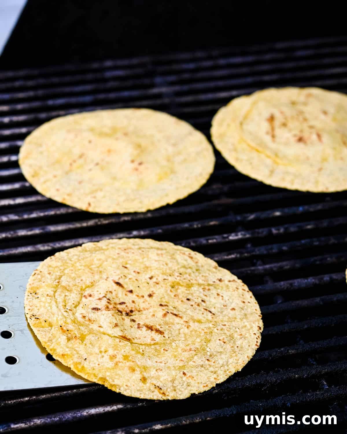Carne Asada Tacos with Juicy Grilled Steak 8 Toasting corn tortillas on the grill.