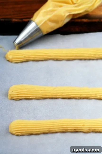 Crispy Baked Churros Recipe with Cinnamon Sugar 2 Snack on baked churros dipped in dulce de leche this Cinco de Mayo! | theredheadbaker.com
