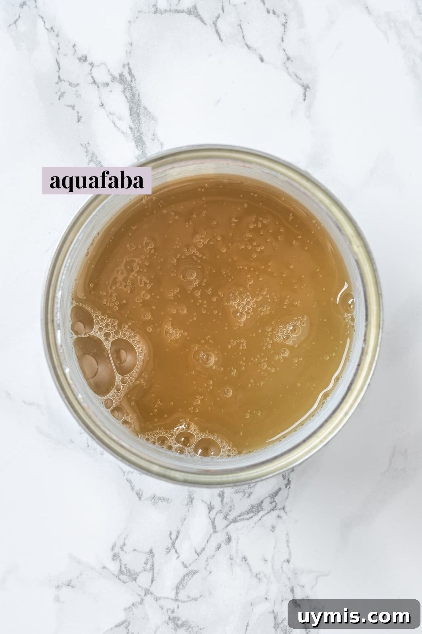 Aquafaba is a miracle worker in vegan baking. But what is aquafaba? And how do you use it? Here’s everything you need to know! Overhead view of liquid from can of chickpeas
