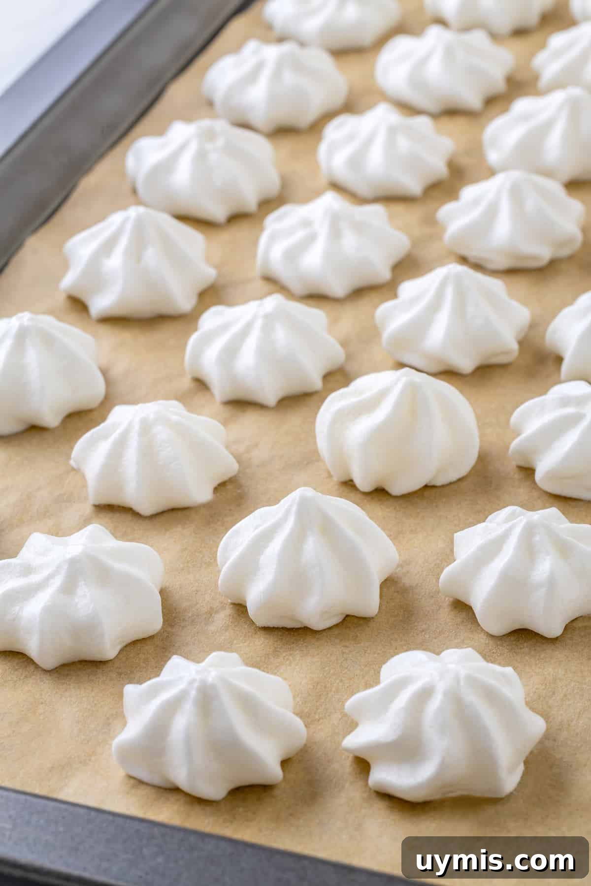 Aquafaba is a miracle worker in vegan baking. But what is aquafaba? And how do you use it? Here’s everything you need to know! Vegan meringues on parchment lined baking sheet
