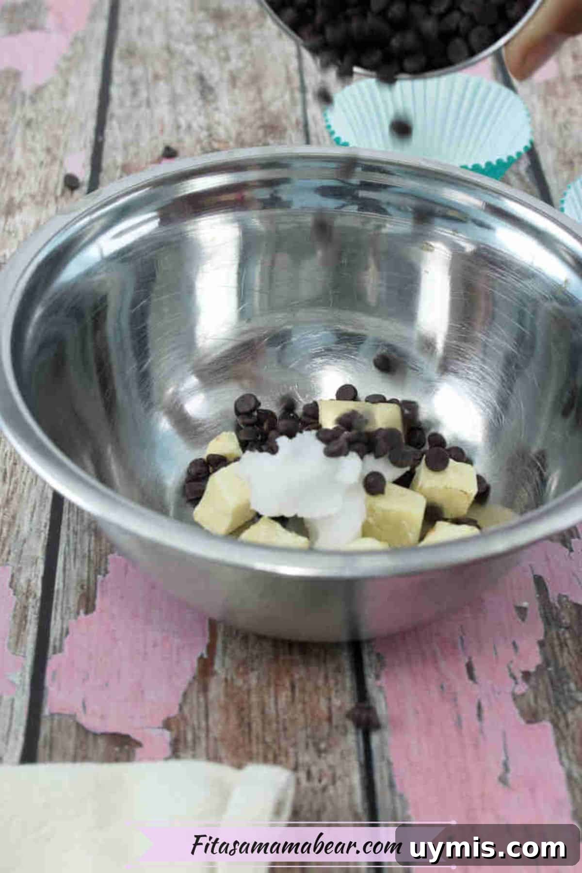 High-Protein Almond Butter Dark Chocolate Cups 4 Steel bowl with chocolate chips, cacao butter and coconut oil in it.