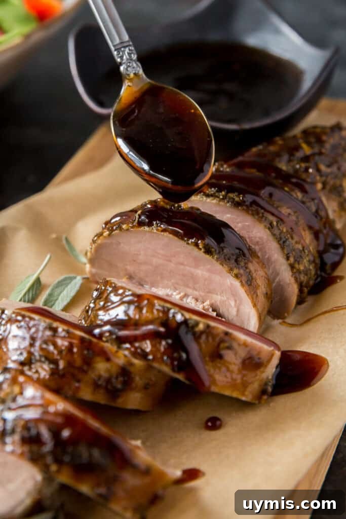 Balsamic Glazed Pork Tenderloin Recipe 7 Balsamic glaze drizzling off a spoon on to sliced pork tenderloin.