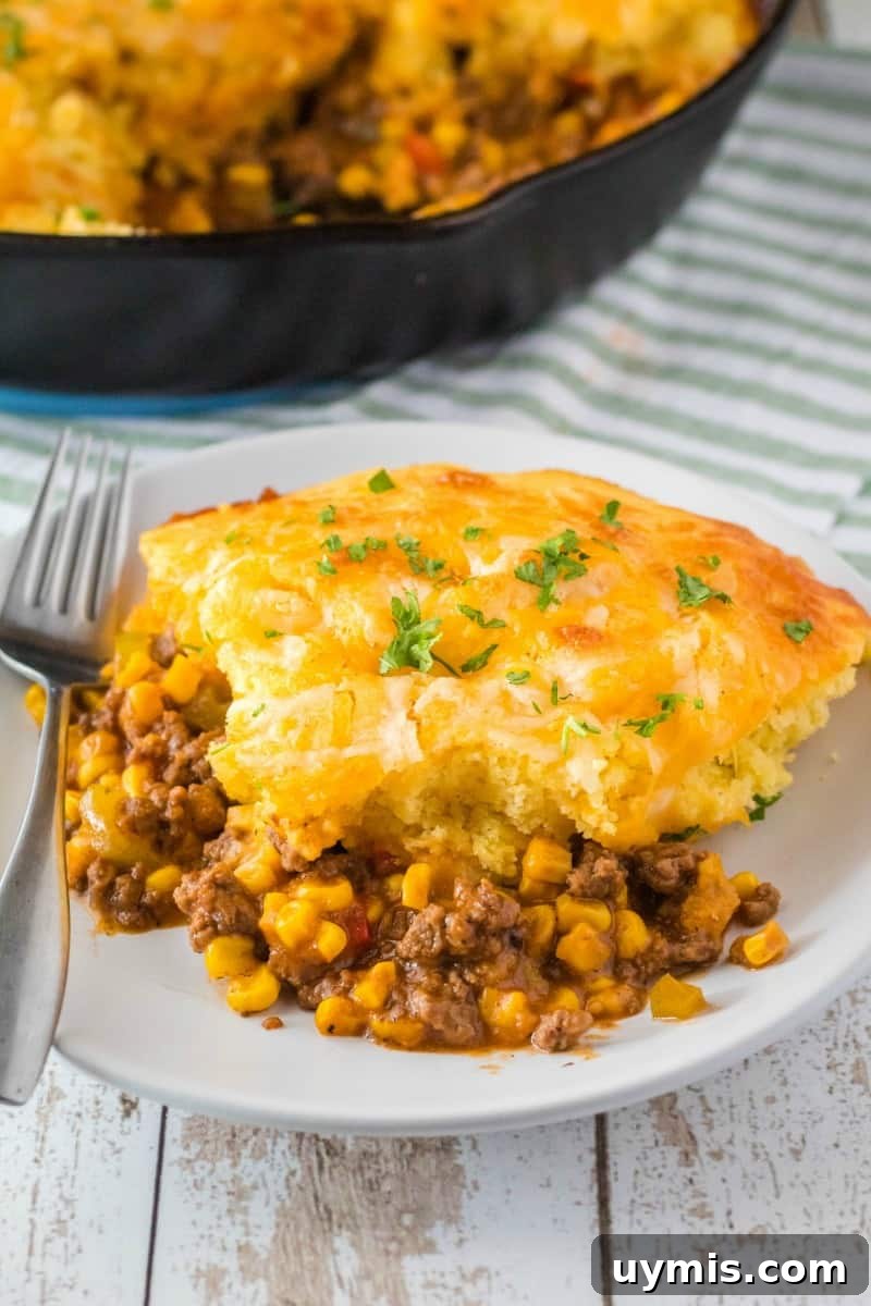 portion of skillet sloppy joe cornbread casserole on a plate with a fork